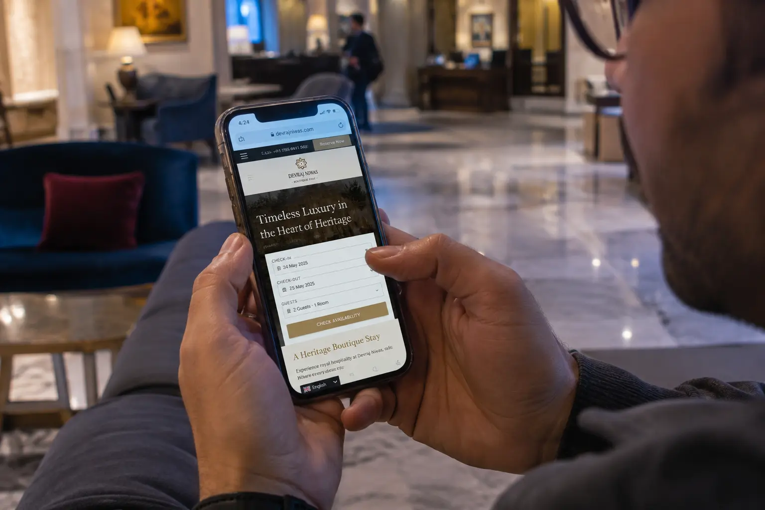 Guest checking a hotel website on a phone in the lobby